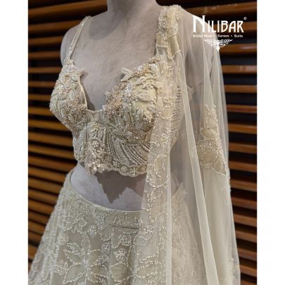 Ivory Net Lehenga Choli Paired With Dupatta