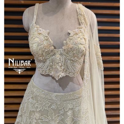 Ivory Net Lehenga Choli Paired With Dupatta