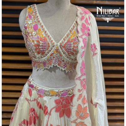Ivory Lame Silk Lehenga Choli Paired With Net Dupatta