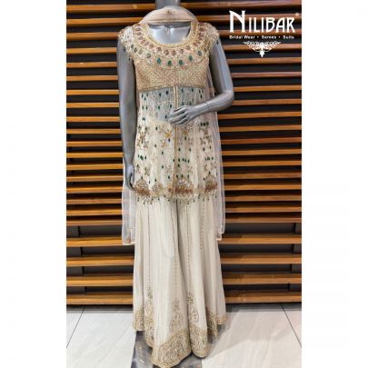 Ivory Peplum Net Shirt Paired With Lame Silk Bottom & Net Dupatta