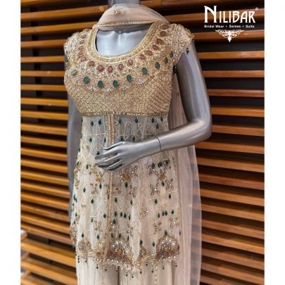 Ivory Peplum Net Shirt Paired With Lame Silk Bottom & Net Dupatta