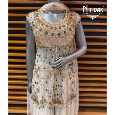 Ivory Peplum Net Shirt Paired With Lame Silk Bottom & Net Dupatta