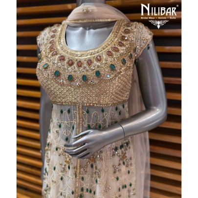 Ivory Peplum Net Shirt Paired With Lame Silk Bottom & Net Dupatta