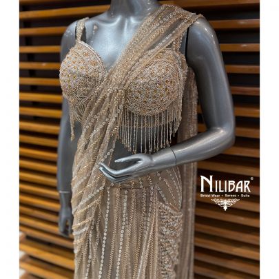 Beige Gold Heavy Embroidered Net Blouse Paired With Pleated Drape Saree