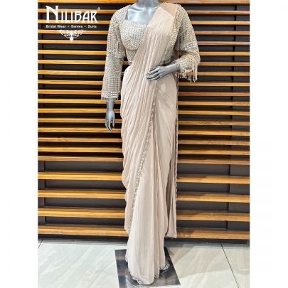 Pale Pink Net Blouse Paired With Georgette Drape Saree
