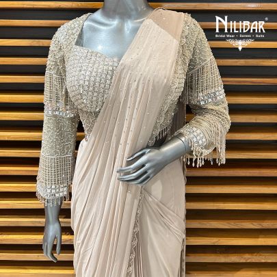 Pale Pink Net Blouse Paired With Georgette Drape Saree
