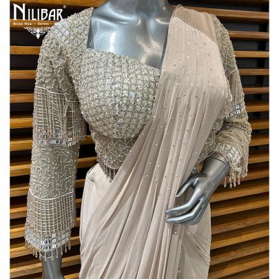 Pale Pink Net Blouse Paired With Georgette Drape Saree
