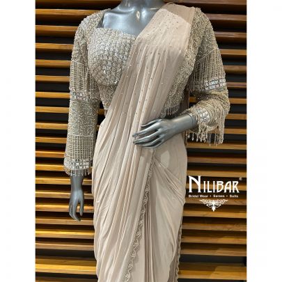 Pale Pink Net Blouse Paired With Georgette Drape Saree