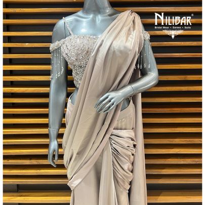 Beige Gold Net Blouse Paired With Satin Drape Saree