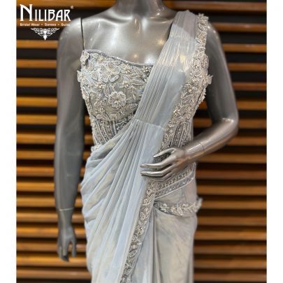 Ice Blue Corset Net Top Paired With Pleated Drape Shimmer Saree