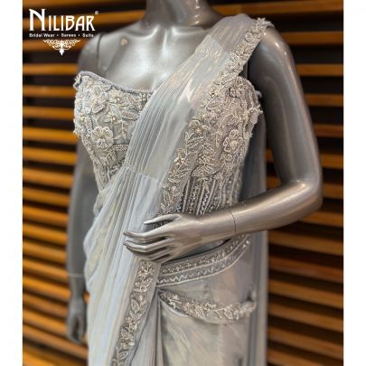Ice Blue Corset Net Top Paired With Pleated Drape Shimmer Saree