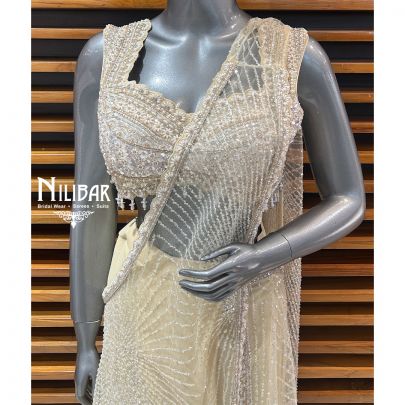 Butterscotch Net Blouse Paired With Lycra Drape Saree