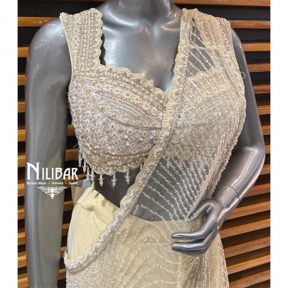 Butterscotch Net Blouse Paired With Lycra Drape Saree