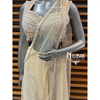 Butterscotch Net Blouse Paired With Lycra Drape Saree