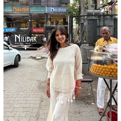 Ivory Cotton Chikankari Top Paired With Bell Bottom